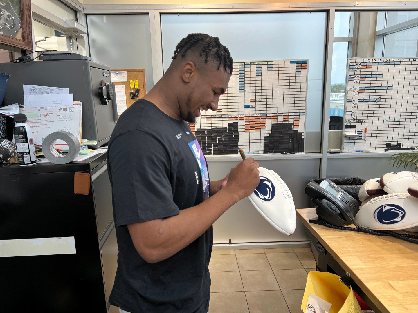 Nick Singleton autographing football