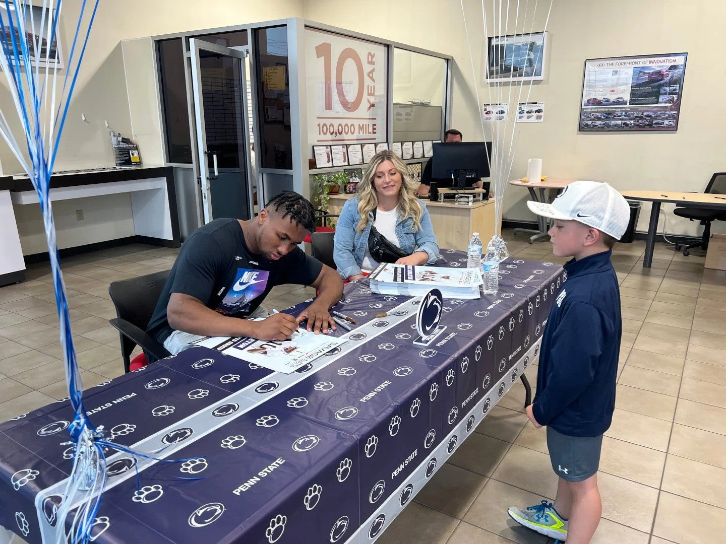 Nick Singleton providing a signature to a young fan