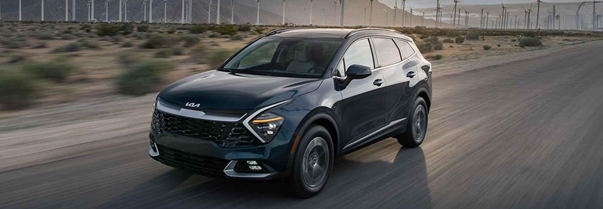 Dark Blue Kia SUV driving on the highway